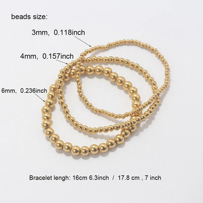 Set aus goldfarbenen Kugelarmbändern